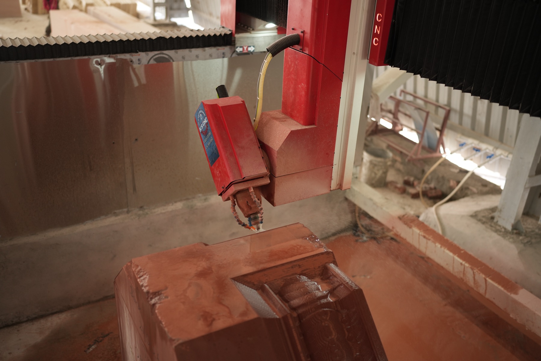 CNC carving station with operator monitoring the cut